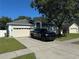 Attractive one-story house with a two-car garage, private driveway, and lush green trees adding curb appeal at 478 Acacia Tree Way, Kissimmee, FL 34758