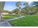 Expansive backyard with mature trees, grassy area, and a shed for storage at 4805 Jay Dr, St Cloud, FL 34772
