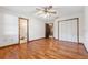 Spacious bedroom features hardwood floors, ceiling fan, closet, and access to an ensuite bathroom at 4805 Jay Dr, St Cloud, FL 34772