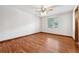 Cozy bedroom with hardwood floors, a ceiling fan, and a view of the outside at 4805 Jay Dr, St Cloud, FL 34772