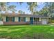 Cozy single-story house with brick accents, blue shutters, and a vibrant green lawn at 4805 Jay Dr, St Cloud, FL 34772