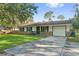 Inviting single-story home with brick accents, a well-kept lawn, and a convenient attached garage at 4805 Jay Dr, St Cloud, FL 34772
