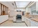 Bright kitchen featuring white appliances, wood countertops, and access to the dining area at 4805 Jay Dr, St Cloud, FL 34772