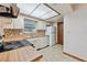 Functional kitchen with white appliances, wood countertops, and ample storage at 4805 Jay Dr, St Cloud, FL 34772