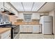 Well-equipped kitchen with white cabinets, wood countertops, and modern appliances at 4805 Jay Dr, St Cloud, FL 34772