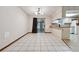 Open kitchen and dining area featuring tile floors, a breakfast bar, and access to the screened patio at 4805 Jay Dr, St Cloud, FL 34772