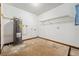 Utility room with a water heater, a wire rack shelf, and stained floor at 4805 Jay Dr, St Cloud, FL 34772