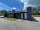 Commercial building exterior featuring dark gray painted brick and a level parking area in front at 4950 Silver Star Rd, Orlando, FL 32808