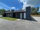 Commercial building exterior with black brick facade, featuring two entry doors and ample parking space at 4950 Silver Star Rd, Orlando, FL 32808