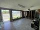 Spacious commercial interior with large windows, tile flooring, and visible wall framing, offering renovation potential at 4950 Silver Star Rd, Orlando, FL 32808