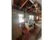 An open, unfinished interior with exposed ceiling structure, featuring vintage furnishing and natural light from windows at 4950 Silver Star Rd, Orlando, FL 32808