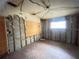 Empty commercial space in need of renovations with exposed block walls, original floors, and a small window at 4950 Silver Star Rd, Orlando, FL 32808