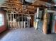 Spacious commercial space needing renovation; open ceiling with visible piping, framing, and small windows at 4950 Silver Star Rd, Orlando, FL 32808