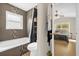 Bathroom with tile detail, a shower and tub combo, and a view into the bedroom at 608 Wechsler Cir, Orlando, FL 32824