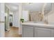 Hall bathroom featuring a gray vanity and a view into a hall and bedroom at 608 Wechsler Cir, Orlando, FL 32824