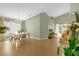 Bright dining area features a chandelier, a dining table with seating for six, and sliding doors to the backyard at 608 Wechsler Cir, Orlando, FL 32824