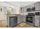 Stylish kitchen with stainless steel appliances and plenty of natural light, open to dining room at 608 Wechsler Cir, Orlando, FL 32824