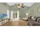 Cozy living room with vaulted ceiling, wood floors, neutral walls, and a view to the patio at 608 Wechsler Cir, Orlando, FL 32824