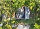 Aerial view of a home with solar panels surrounded by lush greenery at 7043 Carlene Dr, Orlando, FL 32835
