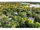 Scenic aerial view showcasing a neighborhood near a lake, with lush greenery and diverse home styles visible at 7043 Carlene Dr, Orlando, FL 32835