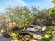 Aerial view of home with solar panels with a covered carport, surrounded by trees at 7043 Carlene Dr, Orlando, FL 32835