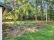 The large, private backyard features lush greenery and mature trees at 7043 Carlene Dr, Orlando, FL 32835