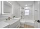 Stylish bathroom with a marble-tiled shower, bathtub, and a modern vanity with gold fixtures at 7043 Carlene Dr, Orlando, FL 32835