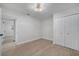 A bedroom with wood-look floors, closet, modern light fixture and doorway at 7043 Carlene Dr, Orlando, FL 32835