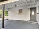 Carport featuring concrete flooring, white-painted block walls, and modern light fixture at 7043 Carlene Dr, Orlando, FL 32835