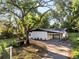 Exterior view of house with solar panels and a covered carport at 7043 Carlene Dr, Orlando, FL 32835