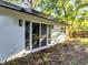 The home has a modern exterior with sleek sliding glass doors and clean lines, perfect for natural light and style at 7043 Carlene Dr, Orlando, FL 32835