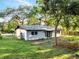 A charming one-story home with mature trees and a well-manicured lawn at 7043 Carlene Dr, Orlando, FL 32835