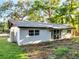 Charming single-story home featuring a freshly painted exterior and a well-maintained yard with mature trees at 7043 Carlene Dr, Orlando, FL 32835