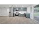 Updated kitchen with stainless steel appliances, gray cabinets, and new countertops at 7043 Carlene Dr, Orlando, FL 32835