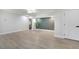 Bright living room with modern flooring, accent wall and a view of the home's entryway at 7043 Carlene Dr, Orlando, FL 32835