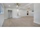 Spacious living room features light wood floors, and neutral walls, with access to multiple rooms at 7043 Carlene Dr, Orlando, FL 32835
