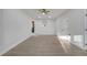 Bright, empty living room with light wood floors, neutral walls, and a window at 7043 Carlene Dr, Orlando, FL 32835