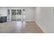 Bright living room with wood floors and sliding glass doors leading to a lush backyard at 7043 Carlene Dr, Orlando, FL 32835