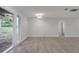 Well lit living room with new floors and light fixture, and glass door leading to the backyard at 7043 Carlene Dr, Orlando, FL 32835