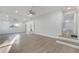 Spacious living room with light wood floors, ceiling fans, recessed lighting, and a hallway entrance at 7043 Carlene Dr, Orlando, FL 32835