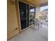 View from the outdoor balcony featuring metal chairs and sliding glass doors to the bedroom at 746 Terra Lago St, Davenport, FL 33897