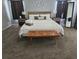 This well-appointed bedroom boasts a king bed, soft grey decor, and a stylish wood bench at 746 Terra Lago St, Davenport, FL 33897