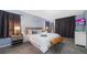 A spacious bedroom featuring a king bed, a modern grey color scheme, and a decorative wood bench at 746 Terra Lago St, Davenport, FL 33897