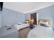 This charming bedroom features two twin beds, grey walls, and tasteful décor at 746 Terra Lago St, Davenport, FL 33897