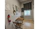 Cozy breakfast nook with a wooden table and chairs, bathed in natural light and featuring a unique wall decor at 746 Terra Lago St, Davenport, FL 33897