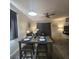 Cozy dining area featuring a modern table set for four, with stylish lighting and decor at 746 Terra Lago St, Davenport, FL 33897