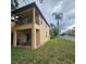 Rear exterior view of home with covered patio and balcony, surrounded by green lawns at 746 Terra Lago St, Davenport, FL 33897