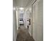 Well-lit hallway with carpet flooring leading to bedrooms, showcasing ample closet space and neat interiors at 746 Terra Lago St, Davenport, FL 33897