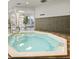 Indoor jacuzzi with tile surround offers relaxation and wellness amenities for residents at 746 Terra Lago St, Davenport, FL 33897