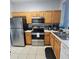 Efficient kitchen with stainless steel appliances, plentiful cabinetry, and tile flooring at 746 Terra Lago St, Davenport, FL 33897